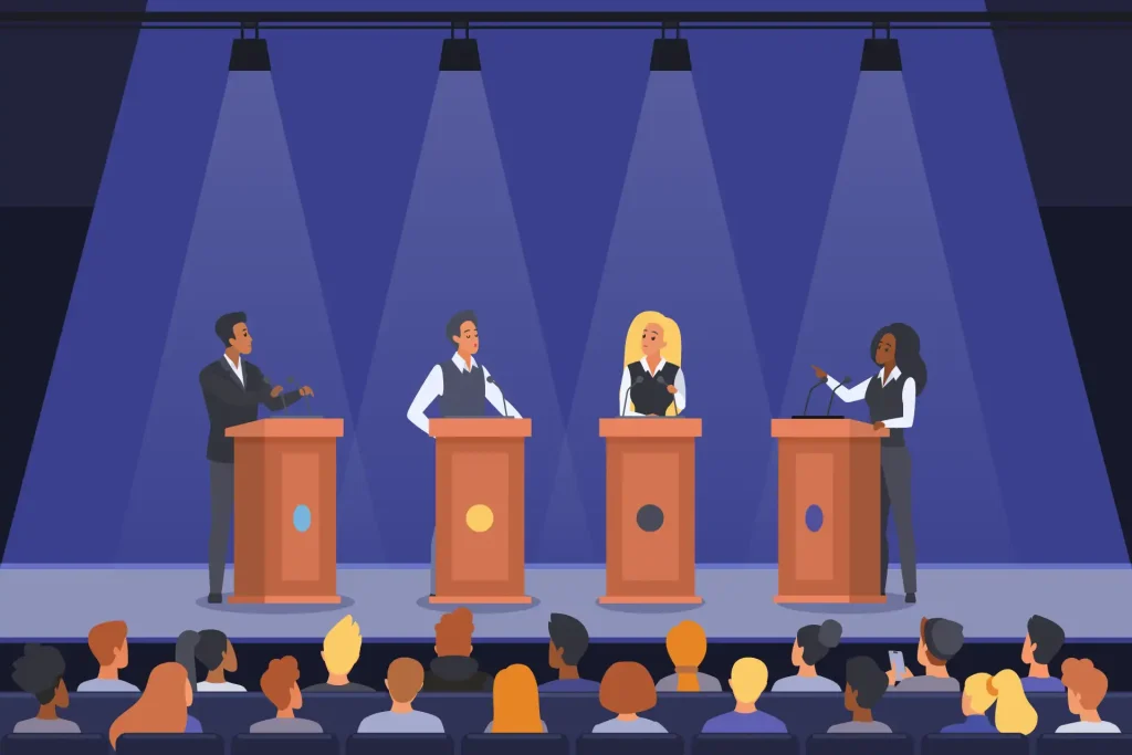 Débat politique sur une scène devant un public, illustrant la participation des entreprises d’économie sociale au débat électoral.